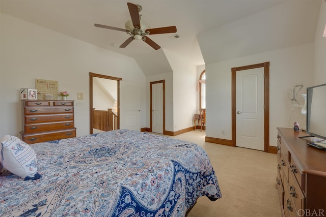 bedroom featuring light colored carpet, visible vents, a ceiling fan, vaulted ceiling, and baseboards