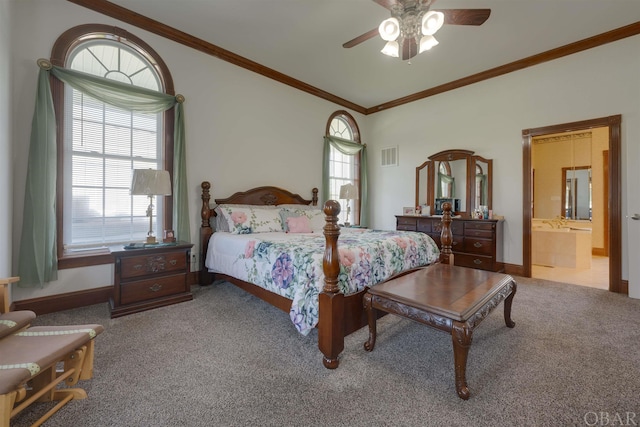 carpeted bedroom with visible vents, ornamental molding, ceiling fan, ensuite bath, and baseboards