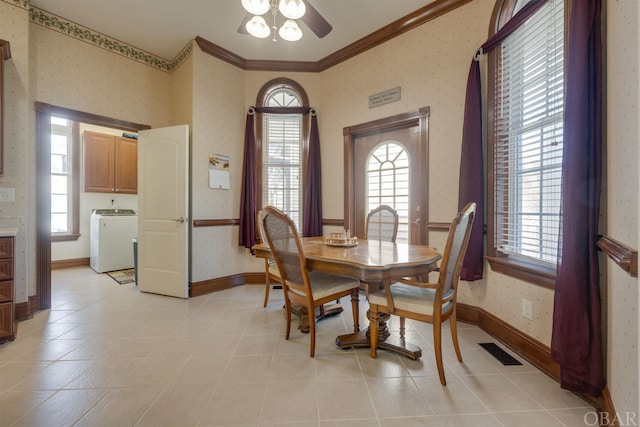 dining room with washer / dryer, visible vents, crown molding, and wallpapered walls