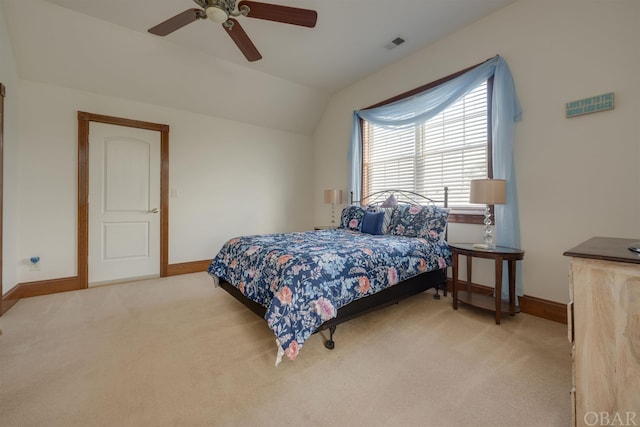 bedroom with lofted ceiling, baseboards, visible vents, and light colored carpet