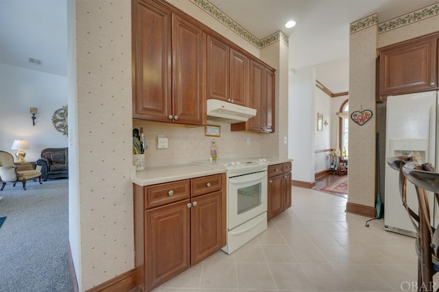 kitchen featuring white appliances, wallpapered walls, brown cabinetry, light countertops, and under cabinet range hood