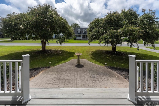 view of community featuring a yard and fence