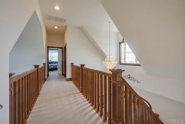 hallway with recessed lighting, visible vents, an inviting chandelier, light carpet, and an upstairs landing