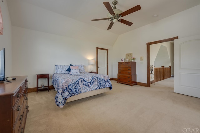 bedroom featuring light carpet, baseboards, a ceiling fan, and lofted ceiling