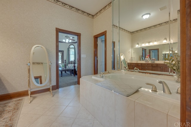 ensuite bathroom featuring baseboards, ensuite bathroom, tile patterned flooring, vanity, and a bath