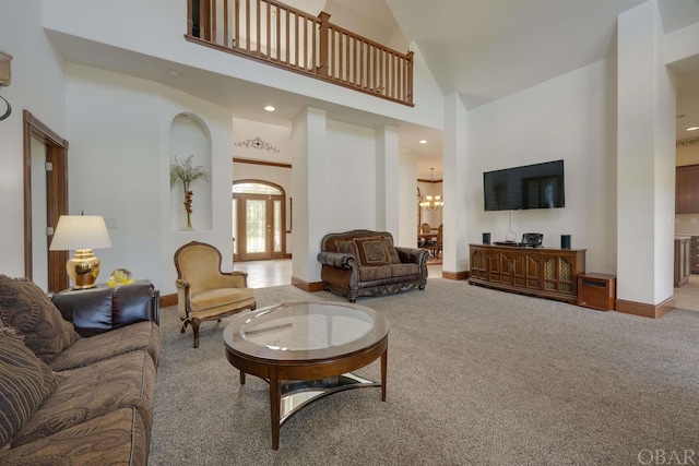 interior space with an inviting chandelier, baseboards, high vaulted ceiling, and recessed lighting