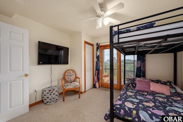 carpeted bedroom with a ceiling fan and baseboards