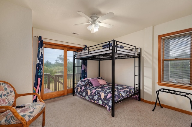 bedroom featuring light carpet, access to exterior, baseboards, and a ceiling fan