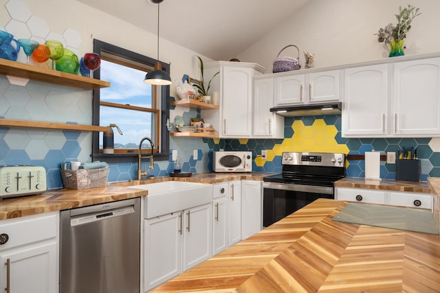 kitchen featuring white cabinets, wooden counters, appliances with stainless steel finishes, open shelves, and pendant lighting