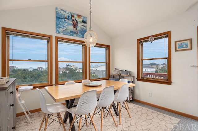 dining space with vaulted ceiling, a mountain view, and baseboards