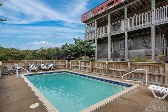 view of pool with a fenced in pool, fence, and a patio