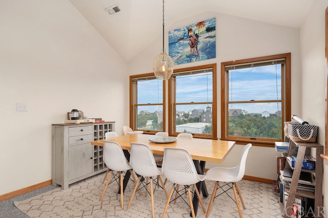 dining area with lofted ceiling, visible vents, and baseboards