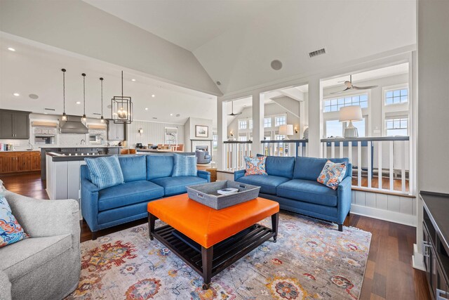 living area with lofted ceiling, visible vents, dark wood-style flooring, and recessed lighting