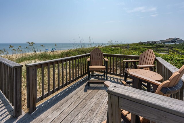 deck featuring a water view and a beach view