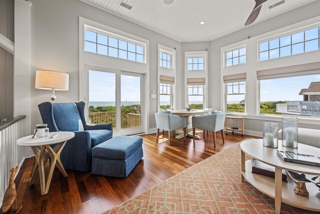 sitting room with wooden ceiling, visible vents, baseboards, and wood finished floors