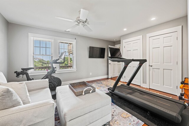 workout room with recessed lighting, wood finished floors, a ceiling fan, and baseboards