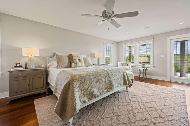 bedroom with access to outside, multiple windows, and dark wood-type flooring