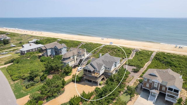 aerial view with a view of the beach, a water view, and a residential view