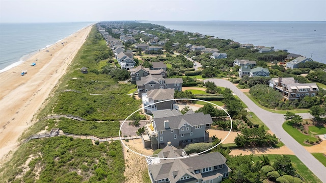 drone / aerial view with a water view, a residential view, and a view of the beach