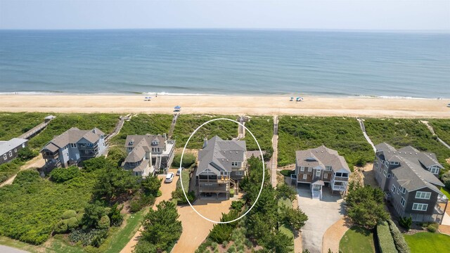 bird's eye view with a residential view, a water view, and a beach view