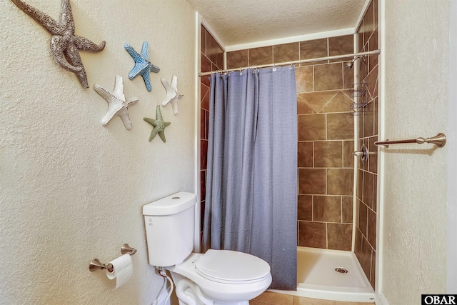 756 Lakeview Ct Lot 47, Corolla, NC 27927 - full bath with toilet, a tile shower, a textured ceiling, and a textured wall