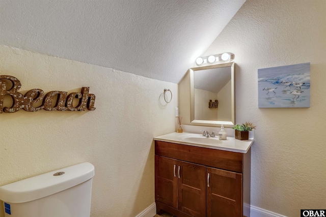 756 Lakeview Ct Lot 47, Corolla, NC 27927 - half bath with lofted ceiling, vanity, toilet, and a textured ceiling