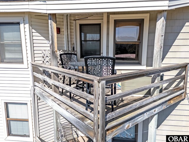 wooden terrace with outdoor dining space