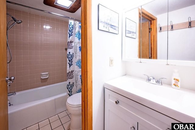 bathroom with tile patterned flooring, vanity, toilet, and shower / bath combo