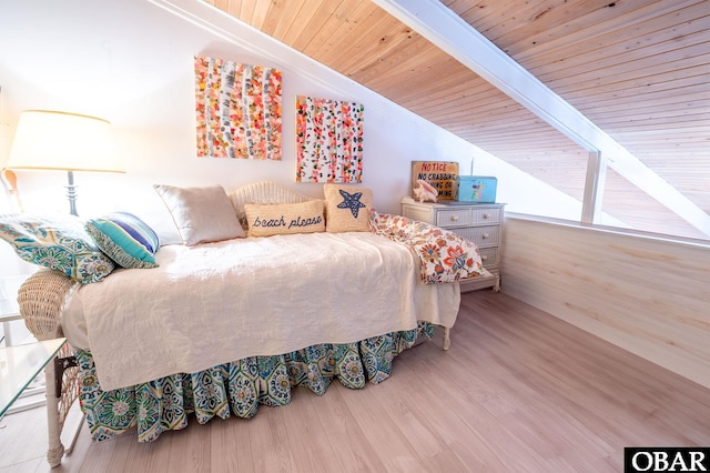 bedroom featuring vaulted ceiling with beams, wood ceiling, and wood finished floors