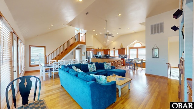 living area featuring light wood-style floors, visible vents, high vaulted ceiling, and recessed lighting