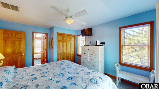 bedroom featuring multiple windows, baseboards, visible vents, and a closet