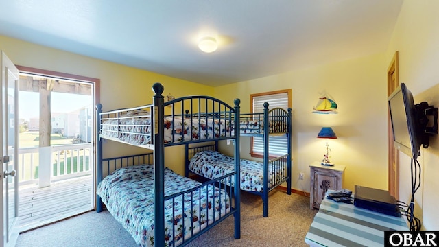 bedroom featuring carpet flooring, access to exterior, multiple windows, and baseboards