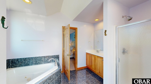 full bathroom featuring vanity, baseboards, a stall shower, a whirlpool tub, and ensuite bathroom