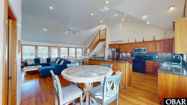 dining room with recessed lighting, high vaulted ceiling, light wood-style flooring, and a ceiling fan