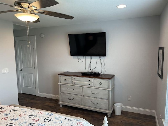 bedroom featuring dark wood-type flooring, a ceiling fan, and baseboards