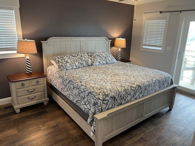 bedroom featuring baseboards and wood finished floors