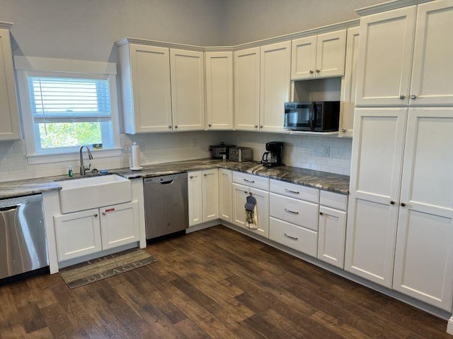 kitchen featuring black microwave, stainless steel dishwasher, a sink, and dark wood finished floors