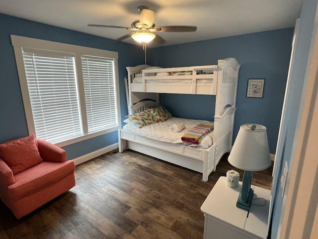 bedroom featuring dark wood finished floors, a ceiling fan, and baseboards