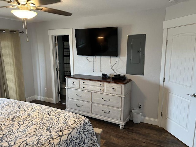 bedroom featuring a ceiling fan, dark wood-style flooring, electric panel, and baseboards