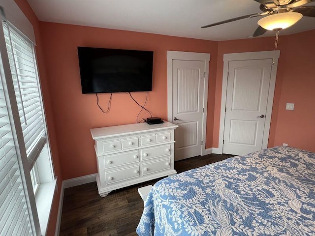 bedroom featuring a ceiling fan, dark wood-style flooring, and baseboards