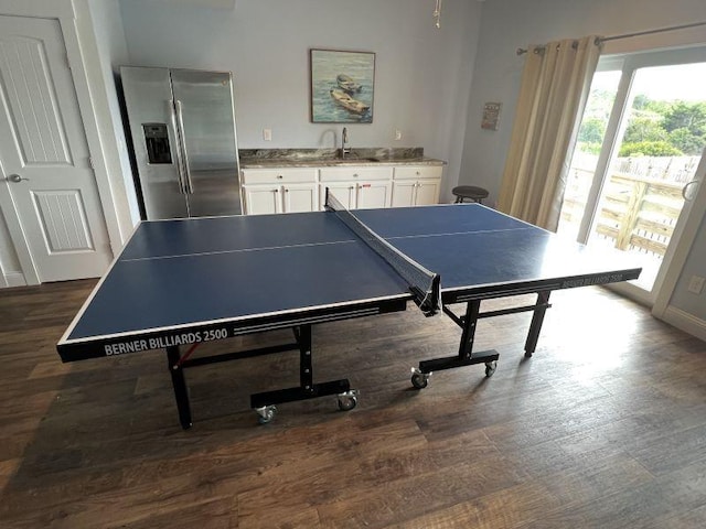 recreation room featuring dark wood-style flooring and a sink