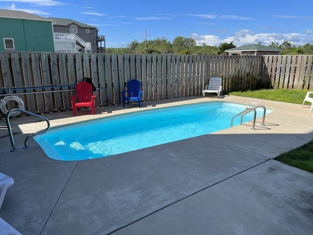 view of swimming pool featuring a patio area, a fenced backyard, and a fenced in pool