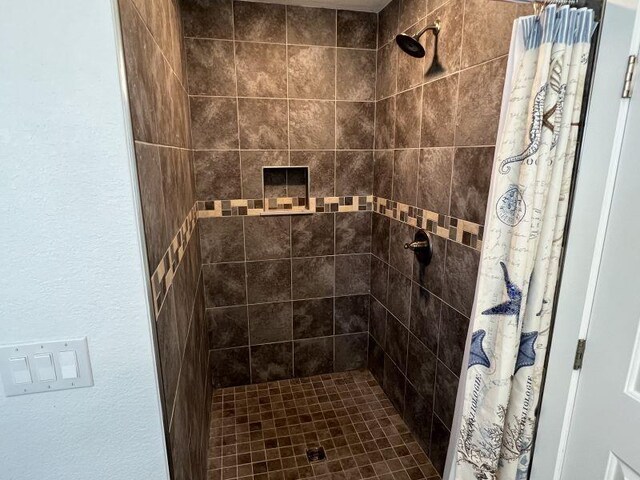 bathroom with a tile shower