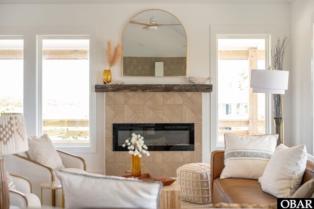 2072 Sandfiddler Rd Lot 85, Corolla, NC 27927 - living area with plenty of natural light, a glass covered fireplace, and ceiling fan