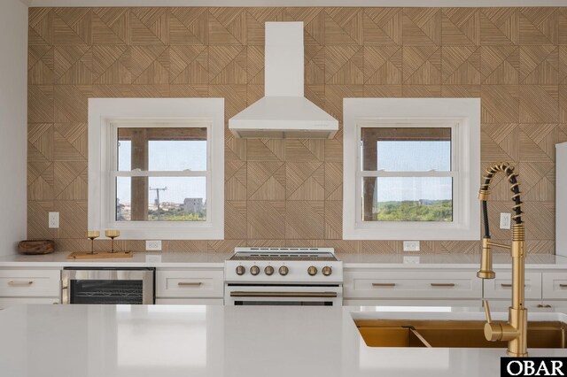 2072 Sandfiddler Rd Lot 85, Corolla, NC 27927 - kitchen with wine cooler, electric range, island range hood, light countertops, and tasteful backsplash