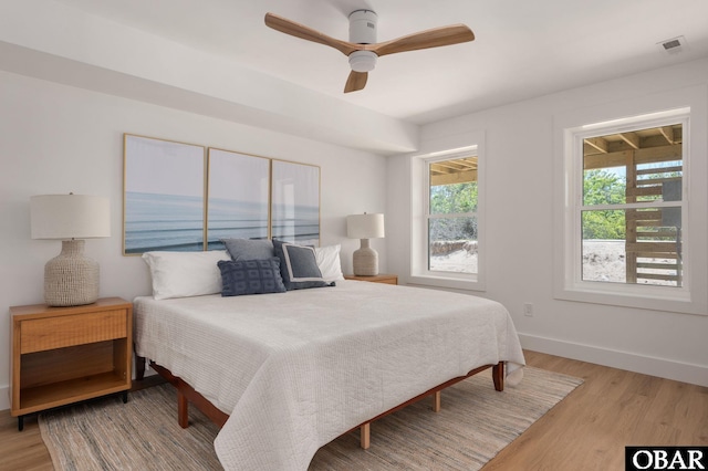2072 Sandfiddler Rd Lot 85, Corolla, NC 27927 - bedroom featuring multiple windows, light wood finished floors, and baseboards