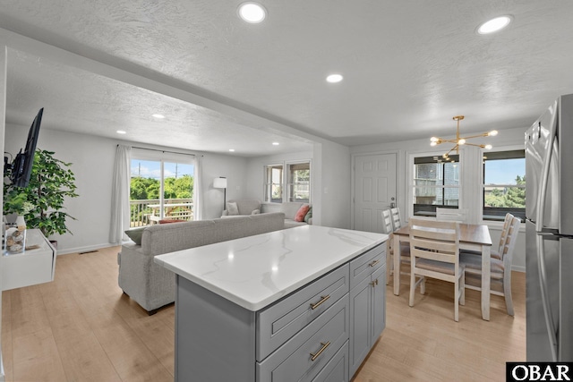 40048 Marlin Dr Lot 152, Avon, NC 27915 - kitchen featuring gray cabinetry, freestanding refrigerator, a chandelier, recessed lighting, and a kitchen island