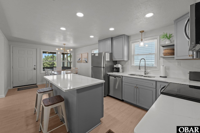 40048 Marlin Dr Lot 152, Avon, NC 27915 - kitchen with a sink, stainless steel appliances, gray cabinets, a center island, and recessed lighting