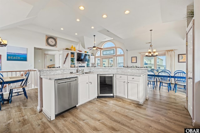 kitchen with wine cooler, stainless steel dishwasher, white cabinetry, pendant lighting, and a sink