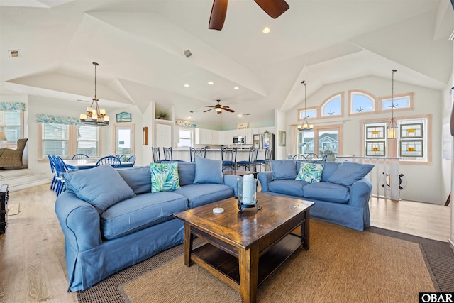 living room with recessed lighting, light wood-style flooring, visible vents, and ceiling fan with notable chandelier